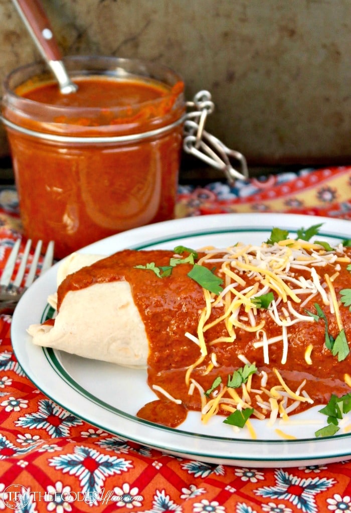 Red enchilada sauce over a buritto