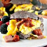 Low Carb Breakfast Sandwich filled with fluffy eggs folded with ham and melted cheese! Serve a crowd or wrap up for a grab and go meal! #breakfast #sandwich #lowcarb #keto | www.thefoodieaffair.com