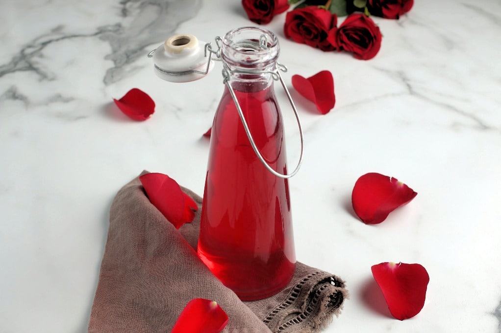 Clear jar with homemade rose water. 