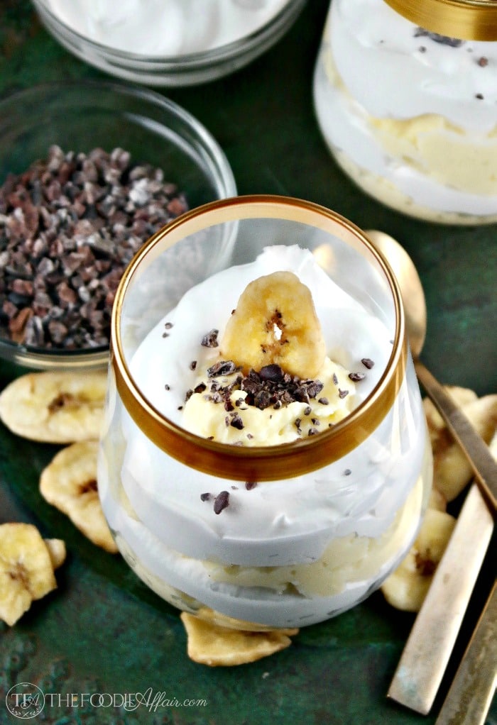 Banana Cream Parfaits in a clear dish with whipped cream