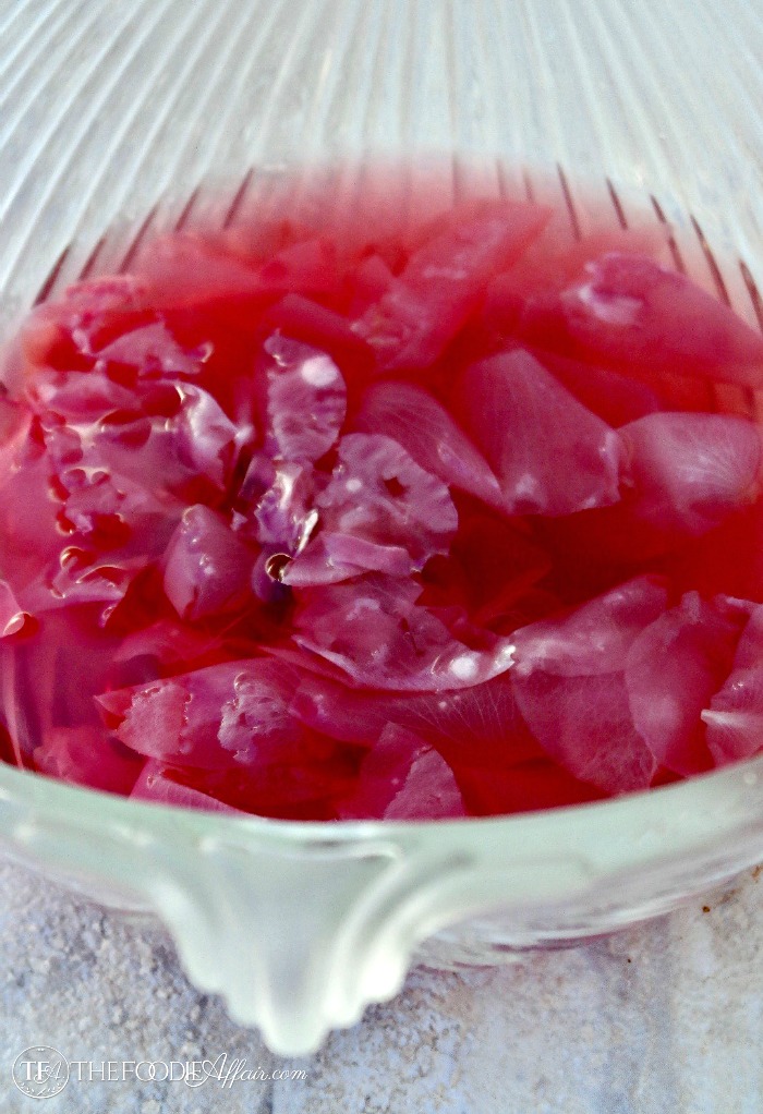 Rose water steeping in a glass bowl #diy #recipe #rosewater | www.thefoodieaffair.com