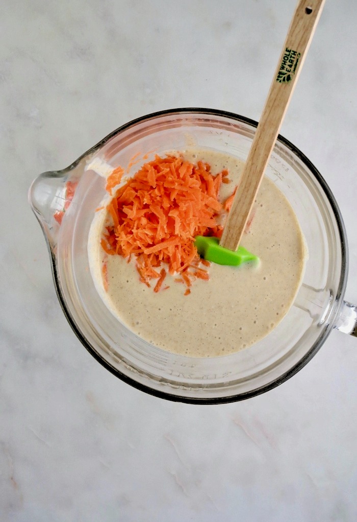 Pancake batter with shredded carrots in a bowl