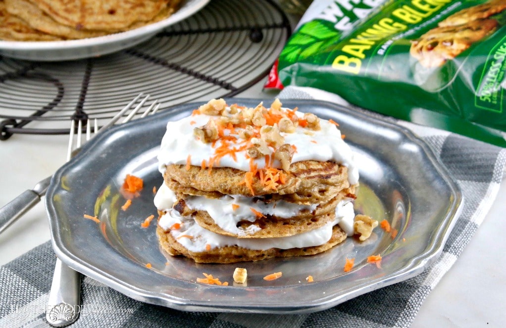 plate of pancakes topped with shredded carrots