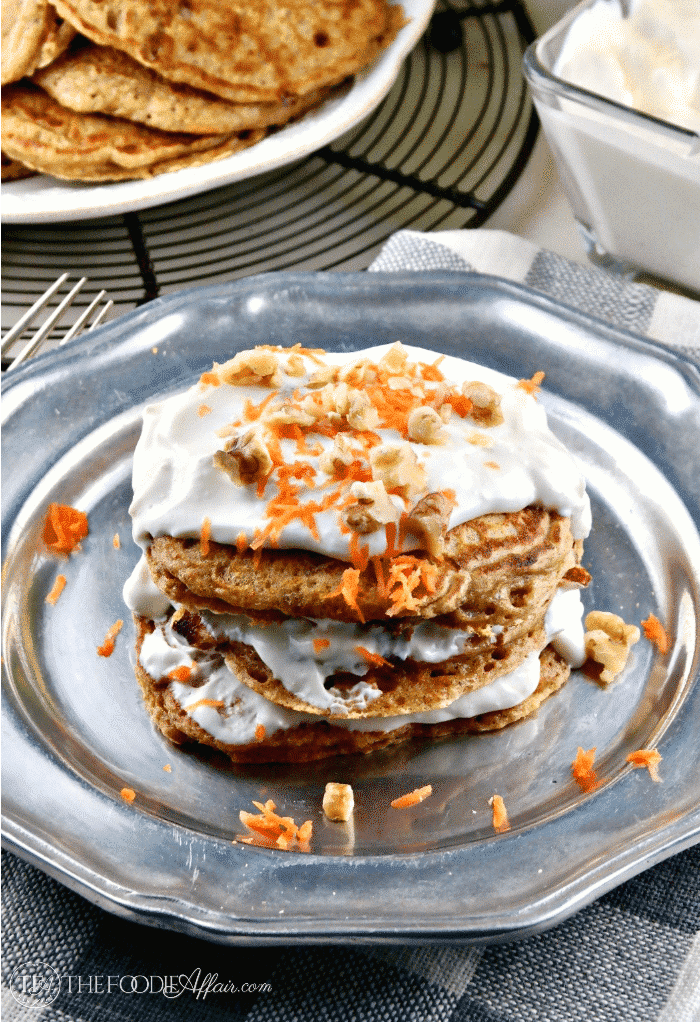 Stack of carrot cake protein pancakes with yogurt topping