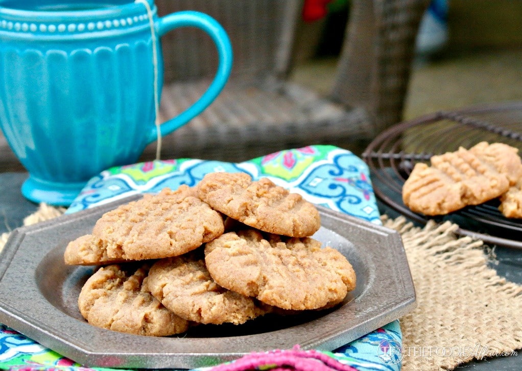 sugar free peanut butter cookies on a tan plate with a blue mug in the background