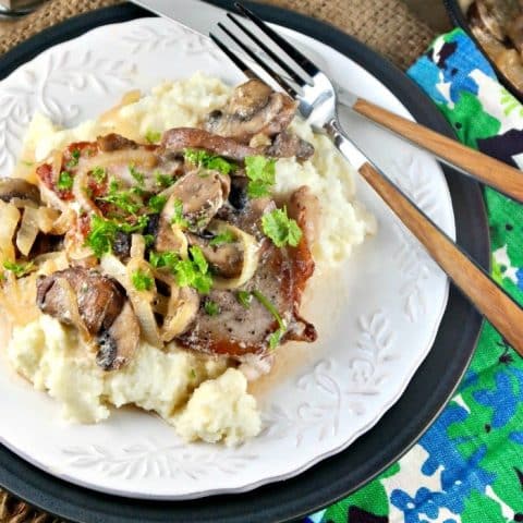 Pork Chops Mushroom Cream Sauce served over mock cauliflower mashed potatoes for a low carb easy skillet meal! #lowcarb #pork #sauce #mushrooms | www.thefoodieaffair.com