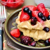 Low carb waffles on a plate topped with berries