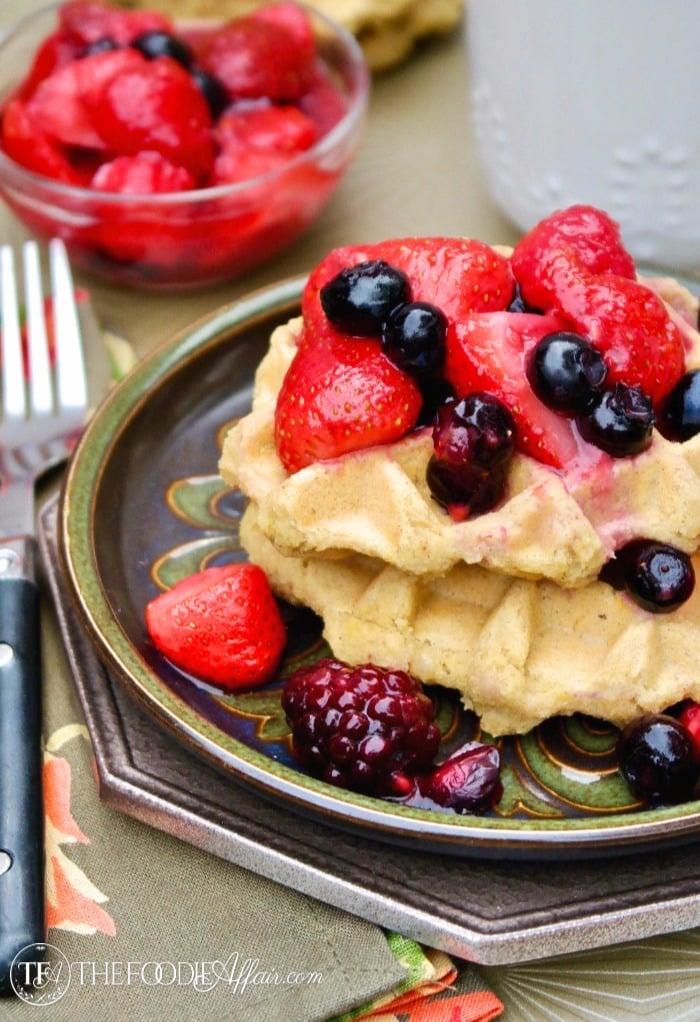 Low carb waffles on a plate topped with berries 
