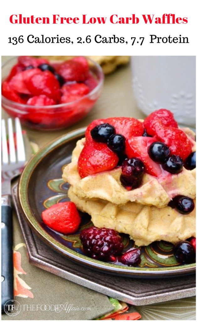 Low Carb Waffles on a green plate topped with red strawberries and purple blueberries