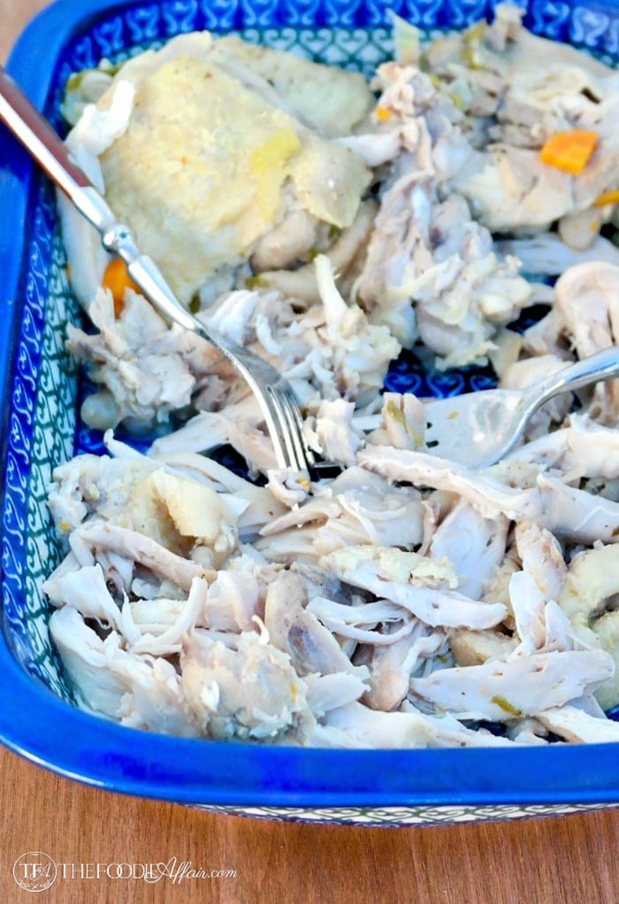 Shredded chicken in a blue baking dish for the Instant Pot Chicken Soup recipe #Soup #InstantPot #Chicken | www.thefoodieaffair.com
