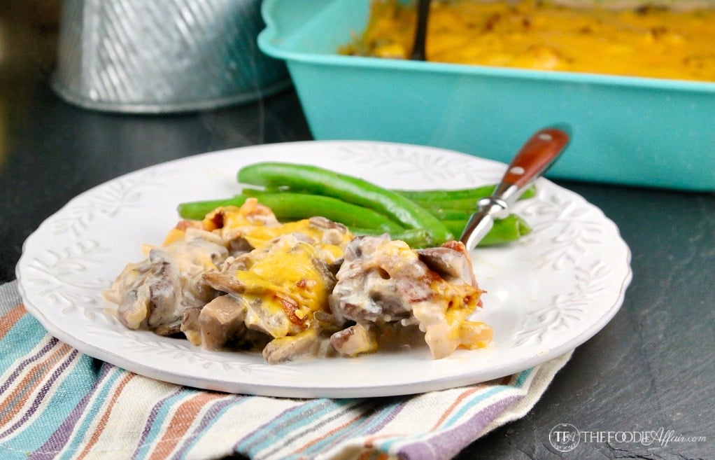 Mushroom Casserole with fresh green beans on a white plate with the casserole in the foreground #casserole #mushroom #lowCarb #Keto | www.thefoodieaffair.com