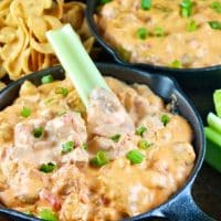Easy appetizer of sausage queso dip for a crowd. Two mini iron skillet pans filled with cheesy dip with chips and celery sticks #dip #queso #sausage | www.thefoodieaffair.com