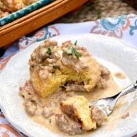 Homemade low carb biscuits and sausage gravy casserole plated on a white dish #sausage #gravy #lowcarb | www.thefoodieaffair.com