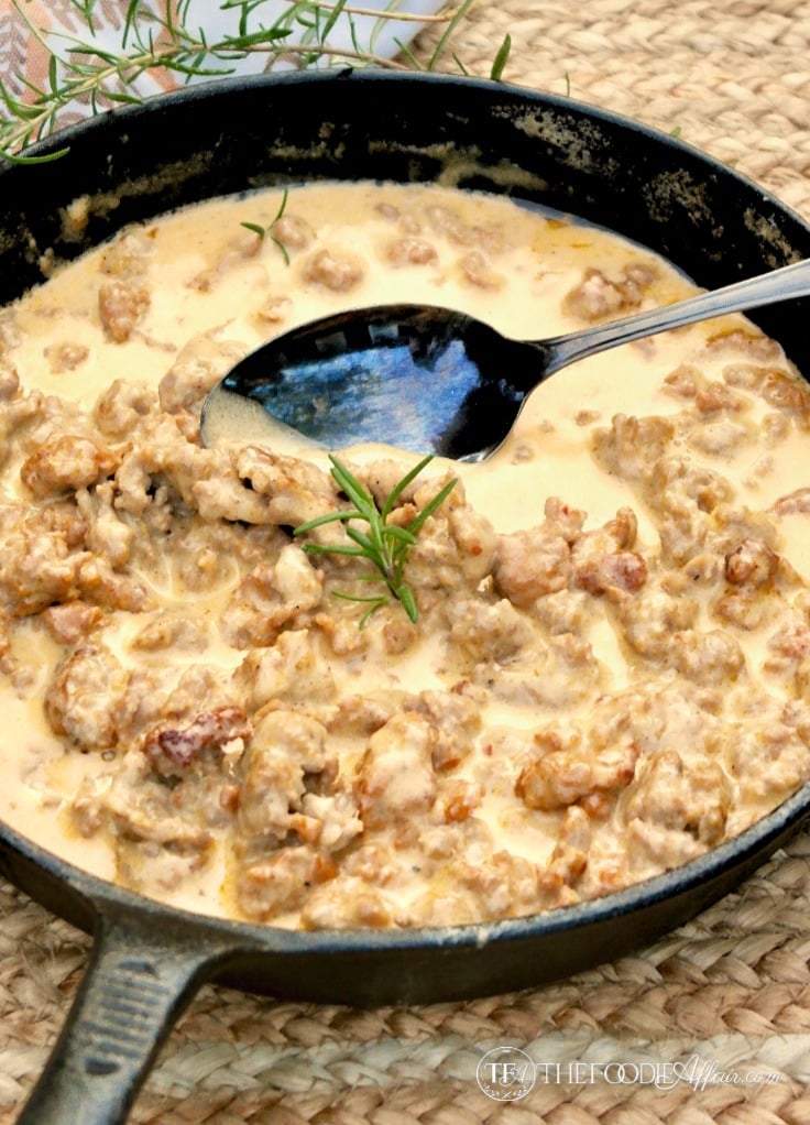 Cast iron skillet with the gravy for a low carb biscuits sausage gravy meal #gravysauce #keto #sausage | www.thefoodieaffair.com
