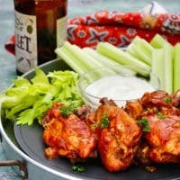 chicken wings on a tray with celery sticks