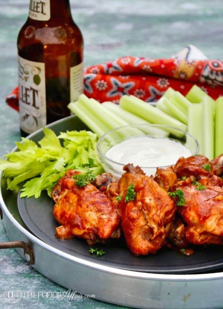 chicken wings on a tray with celery sticks