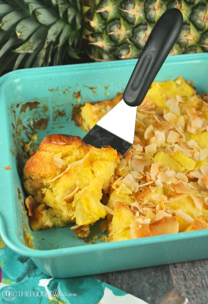 Pineapple bread pudding in a teal baking dish