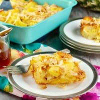 Pineapple bread pudding on a silver lined white plate