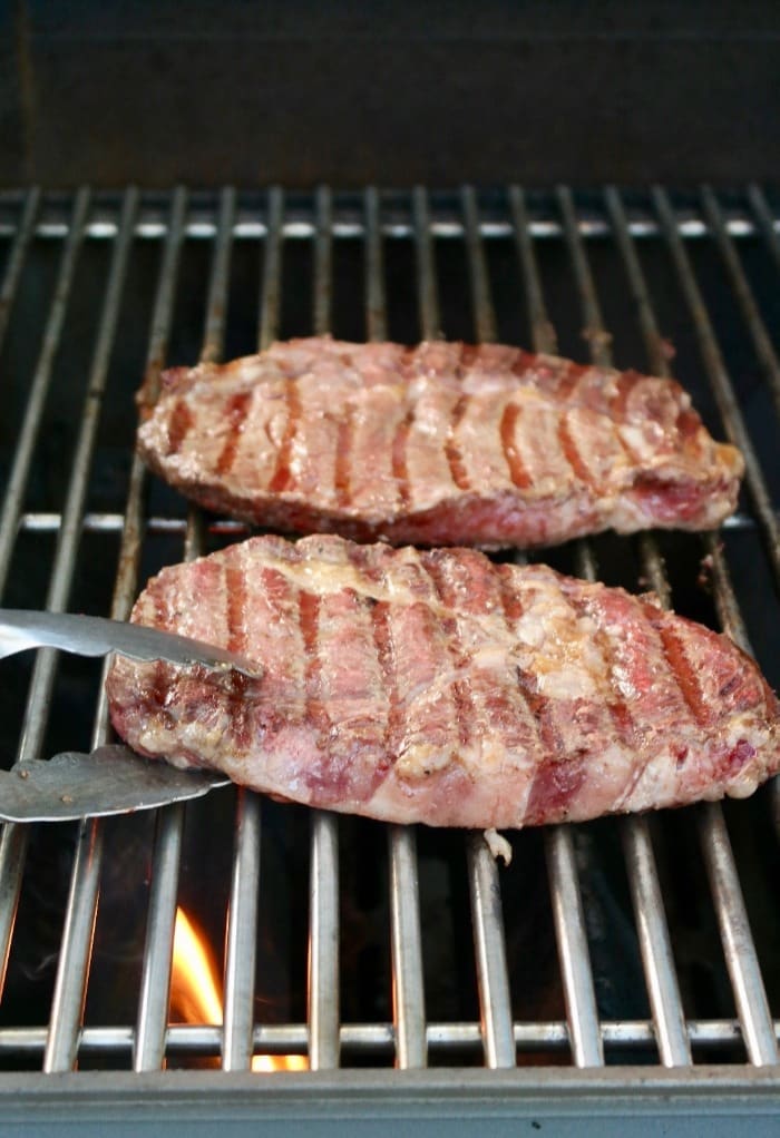 Rib eye steak on grill grates