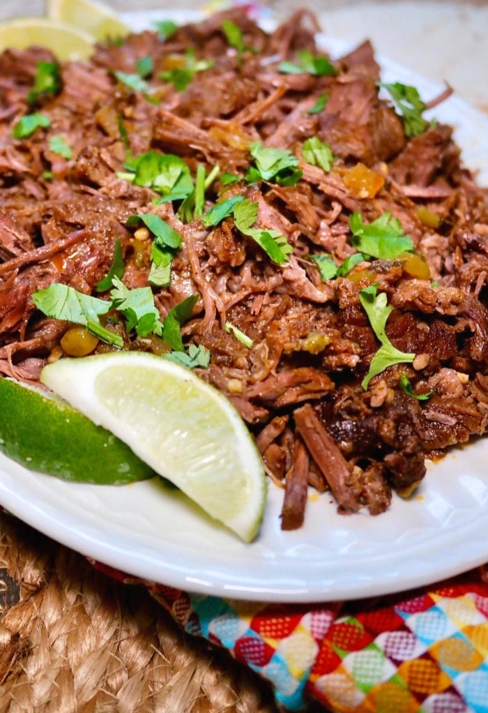 Mexican flavored beef on a white plate with cilantro