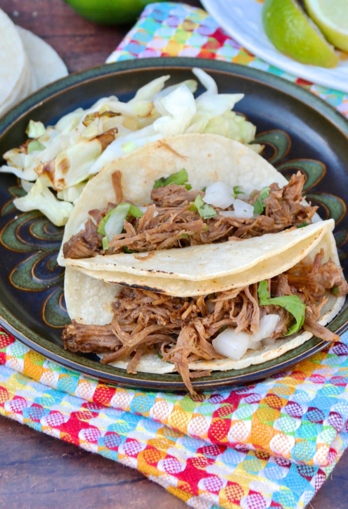 plate of street tacos with shredded beef on a brown plate