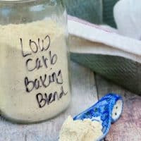 Clear mason jar of low carb baking mix with a blue spoon full of blend