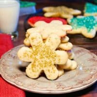 Snow flake cut out cookies on a tan plate