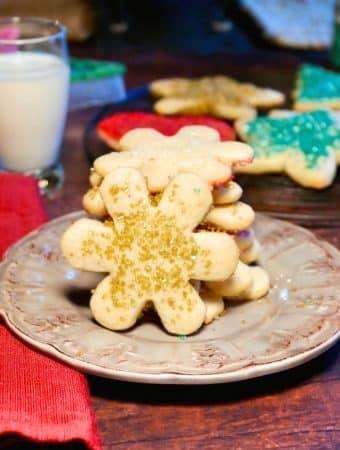 Snow flake cut out cookies on a tan plate