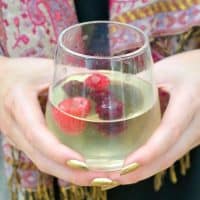 Limoncello spritz cocktail in a clear glass with fresh berries