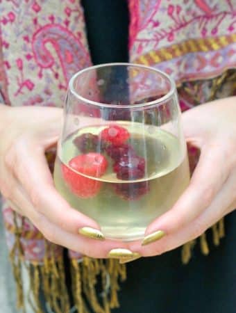 Limoncello spritz cocktail in a clear glass with fresh berries