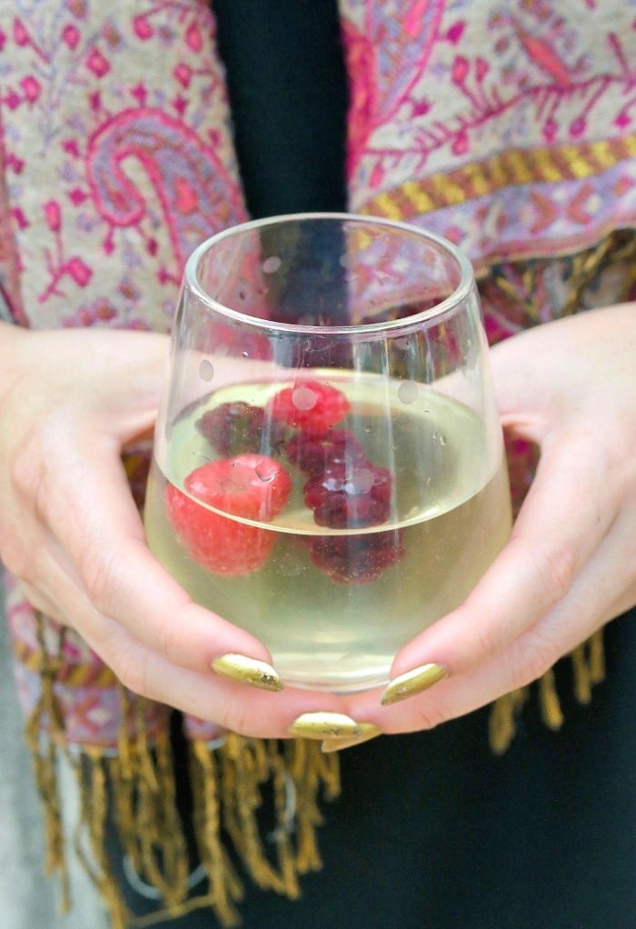 Limoncello spritz cocktail in a clear glass with fresh berries