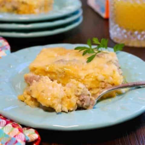 Cheesy egg sausage casserole on a teal plate