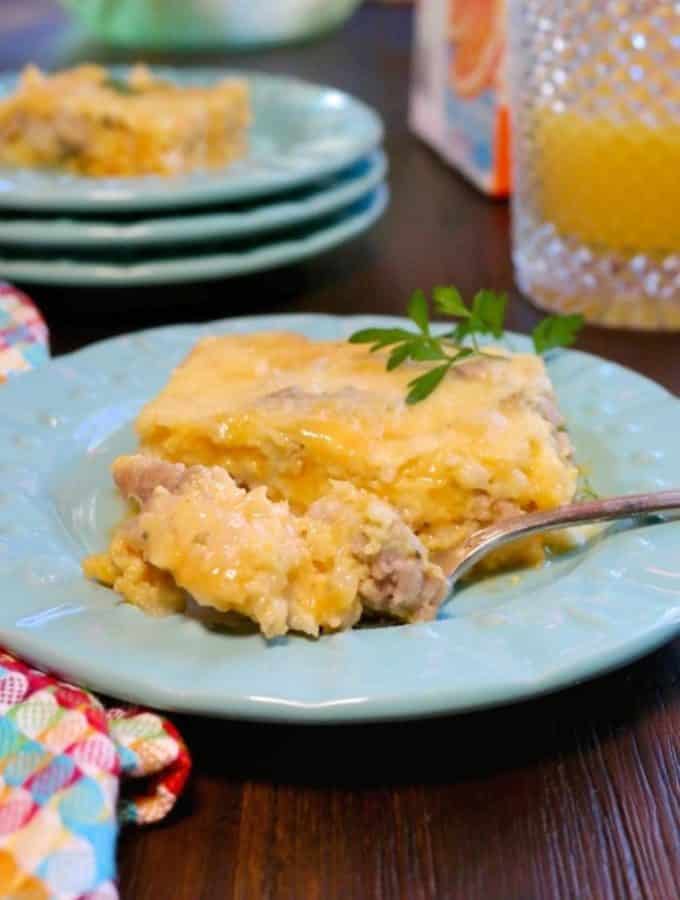 Cheesy egg sausage casserole on a teal plate