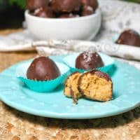 Chocolate peanut butter fat bombs on a teal plate