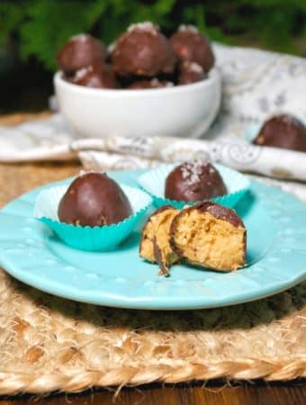 Chocolate peanut butter fat bombs on a teal plate