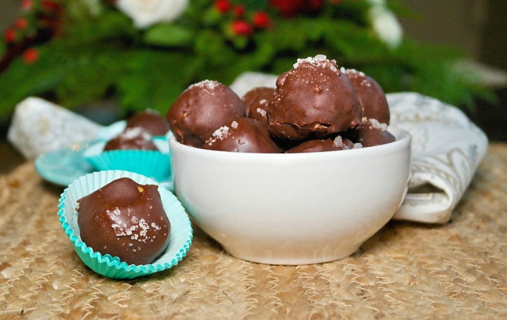 Chocolate peanut butter fat bombs with sea salt on top in a white bowl