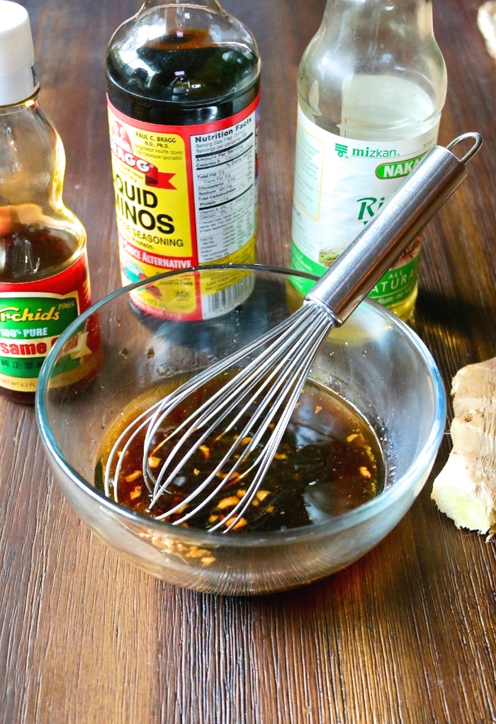 Stir fry sauce ingredients in a clear bowl with a whisk