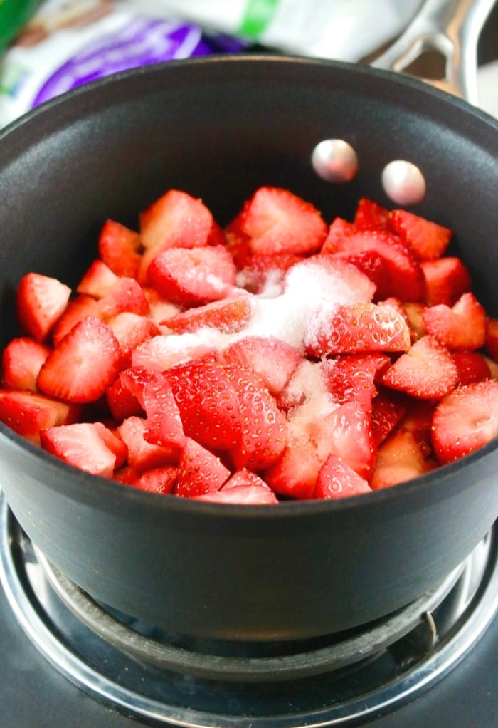 chopped strawberries in a saucepan cooking strawberry puree