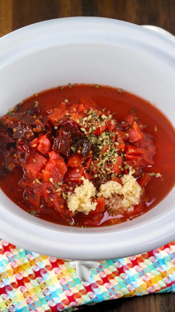 Chipotle sauce in a white crockpot for slow cooked meatballs