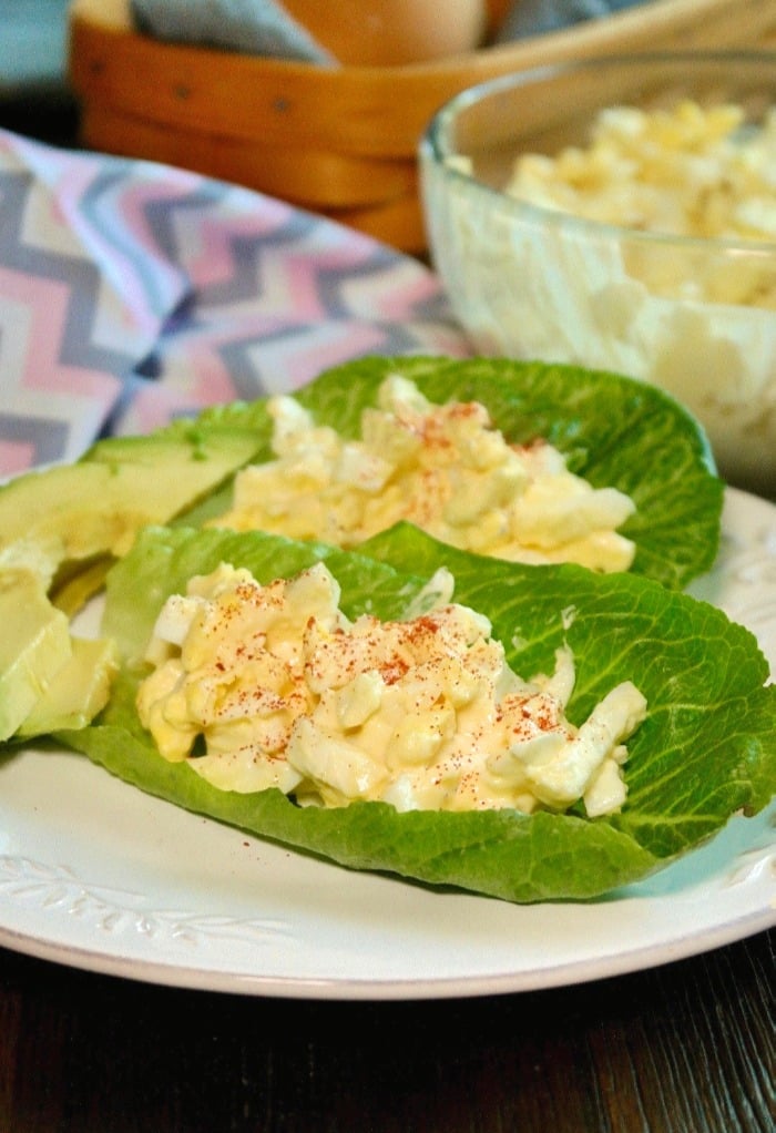 Keto egg salad in lettuce leaves with avocado slices