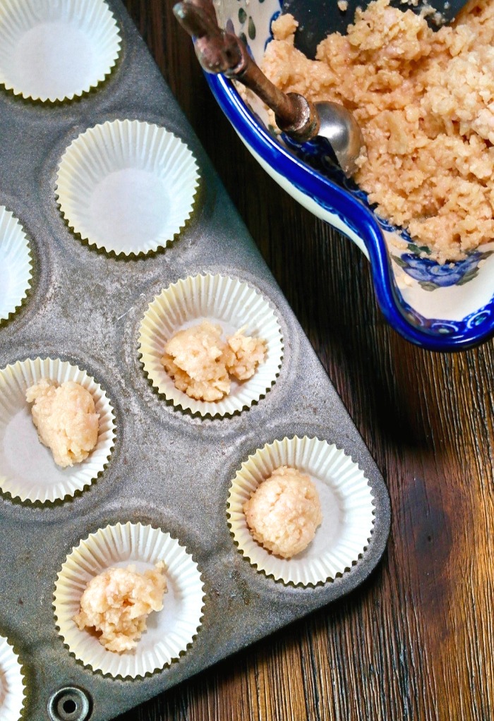 mini cheesecake crust crumbs in small cupcake lined baking pan