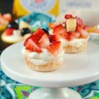 No Bake mini cheesecake recipe on a white small pedestal with floral napkin