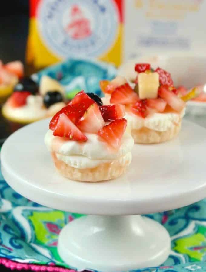 No Bake mini cheesecake recipe on a white small pedestal with floral napkin