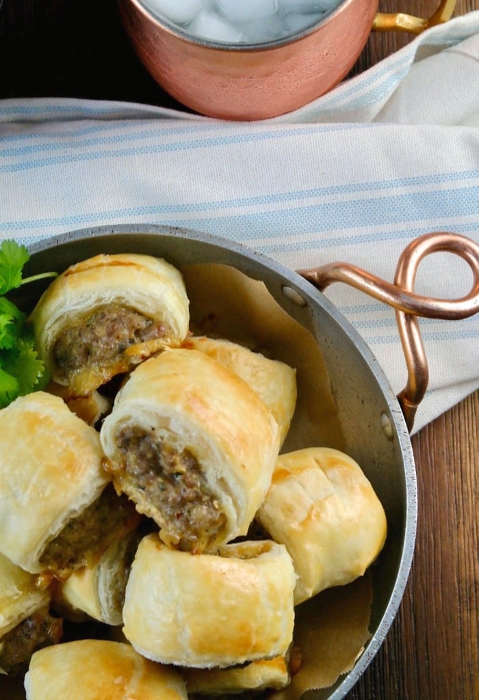 Pewter bowl with sausage rolls