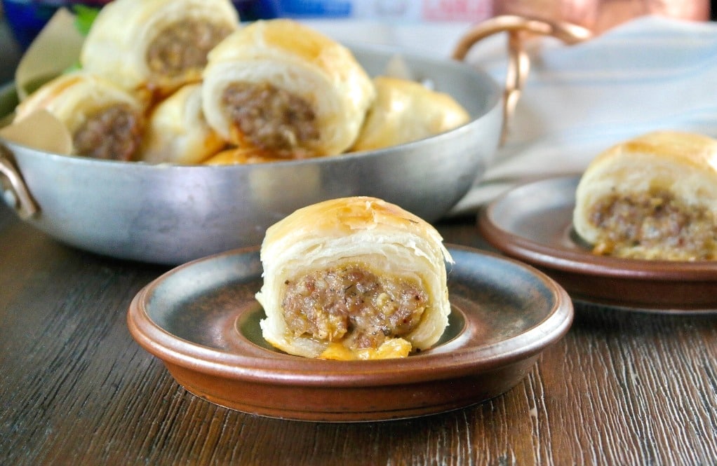 sausage roll in puff pastry on a brown appetizer plate