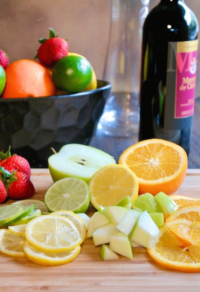 Diced fruit on a cutting board for Spanish sangria