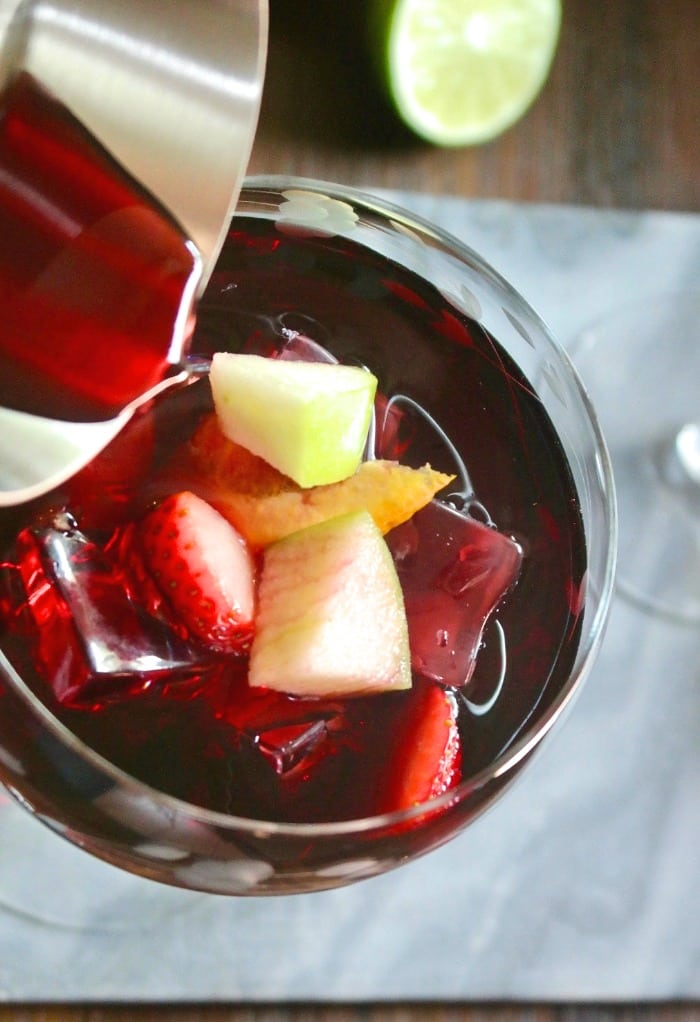 Top of a wine glass filled with red wine Spanish sangria and diced fruit