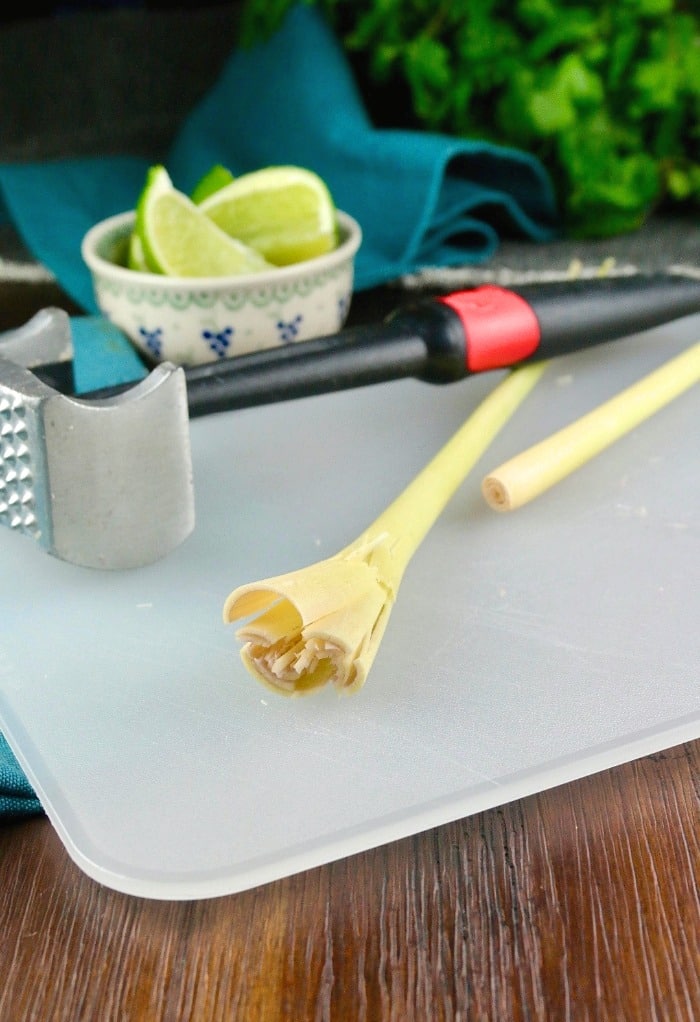 Smashed lemongrass on a cutting board for Thai coconut soup