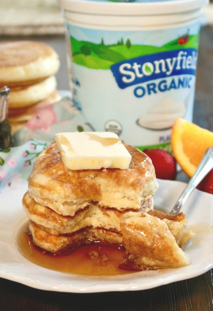 a stack of fluffy pancakes on a white plate