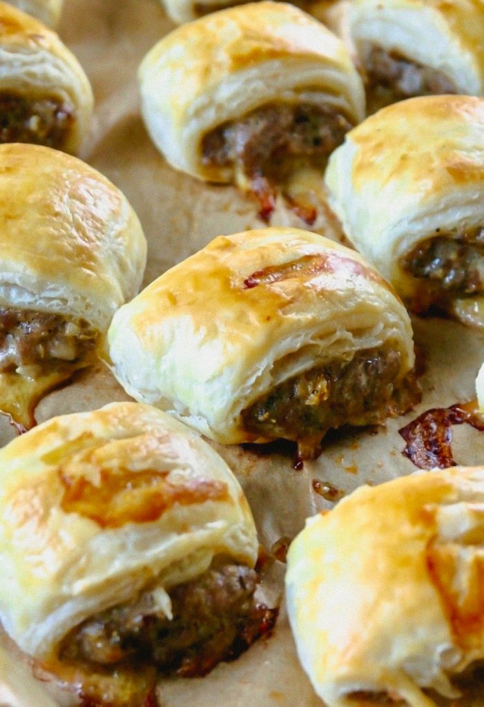 Sausage Rolls freshly baked on a parchment paper. 